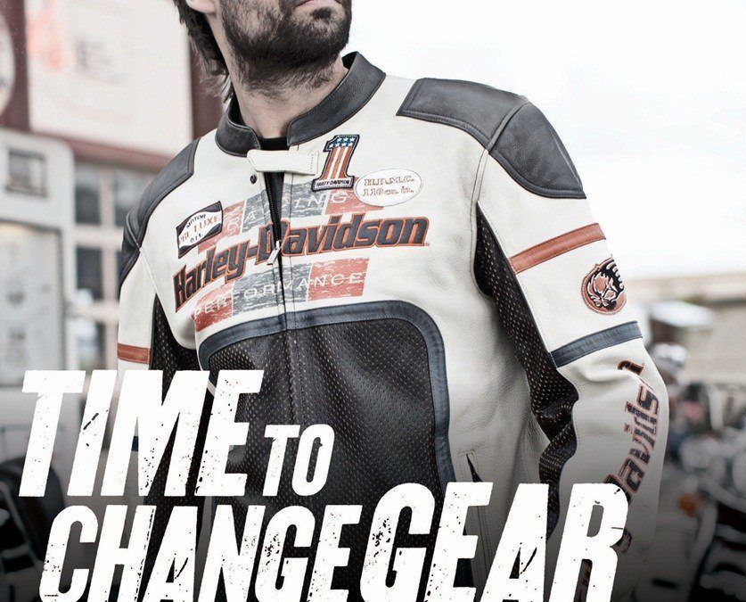 Man wears white and black Harley-Davidson racing jacket.