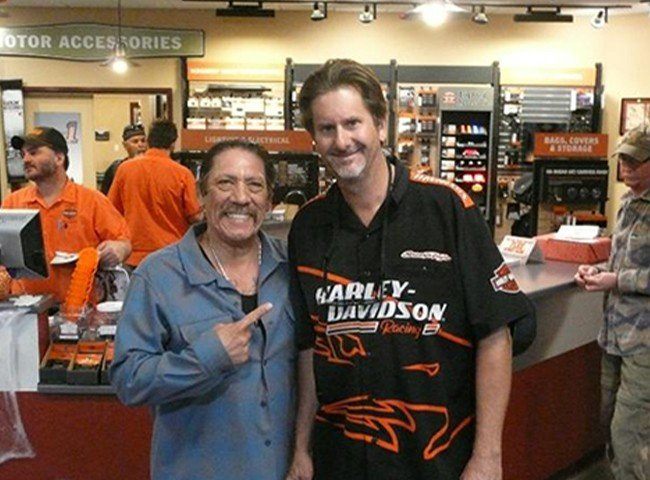 Danny Trejo shakes hands with a staff member.
