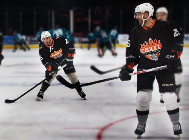 Hockey players in mid-game on an ice rink.